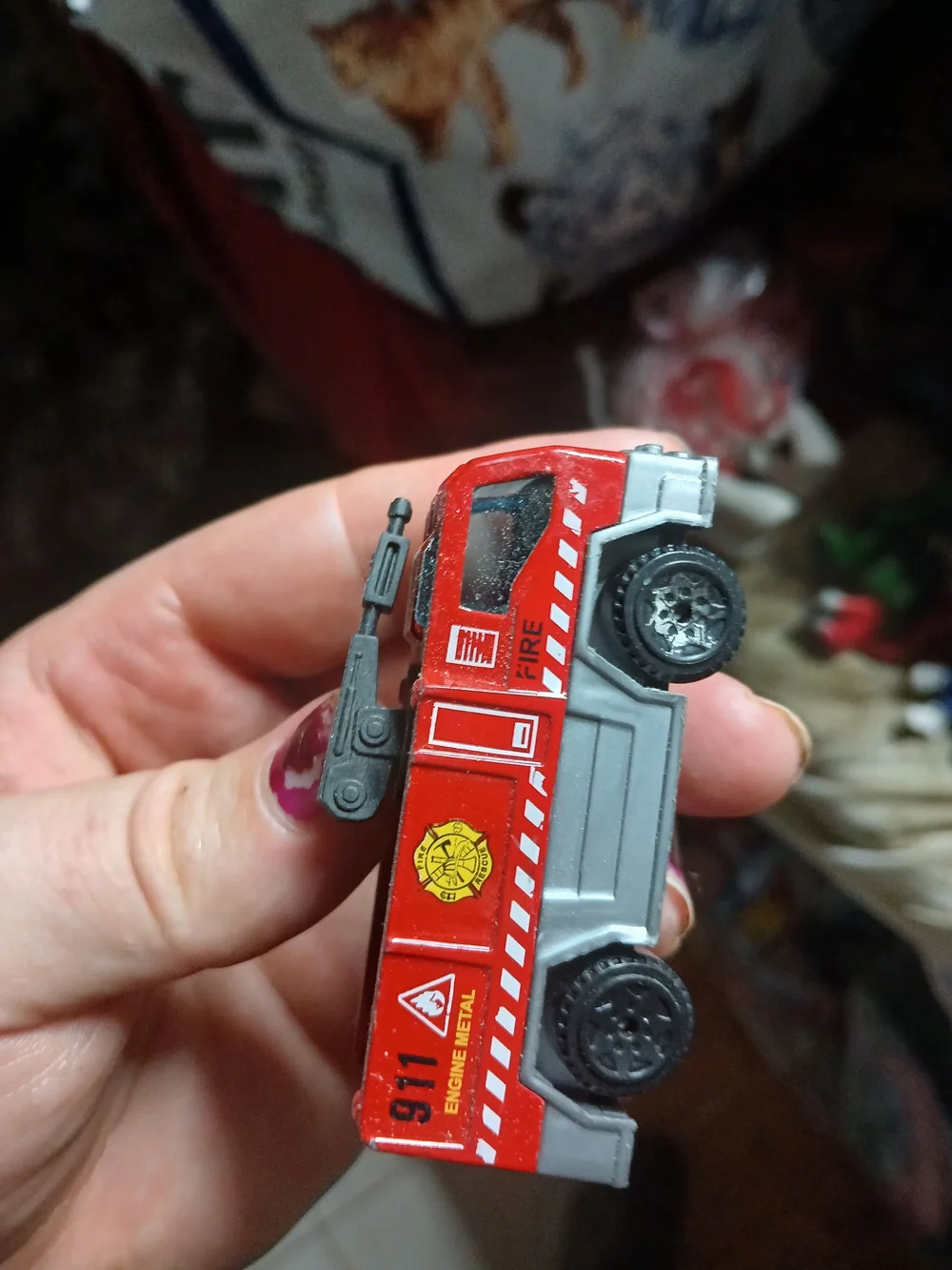 Matchbox Airport Fire Tanker toy vehicle, featuring a red body and a black water